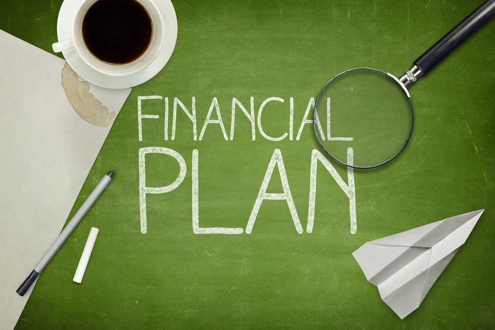 Financial plan concept on blackboard with empty paper sheet