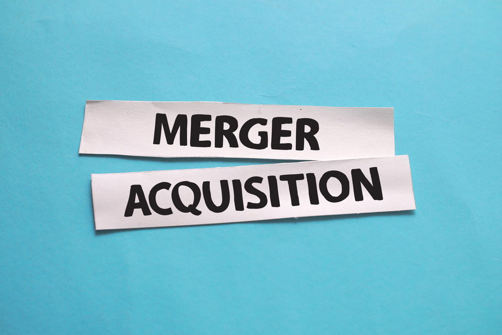 Merger and Acquisition, text words typography written on paper a