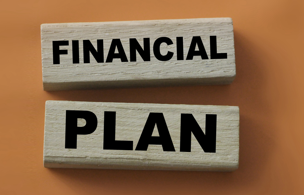 Two wooden blocks with the inscription financial plan lon red. Business concept